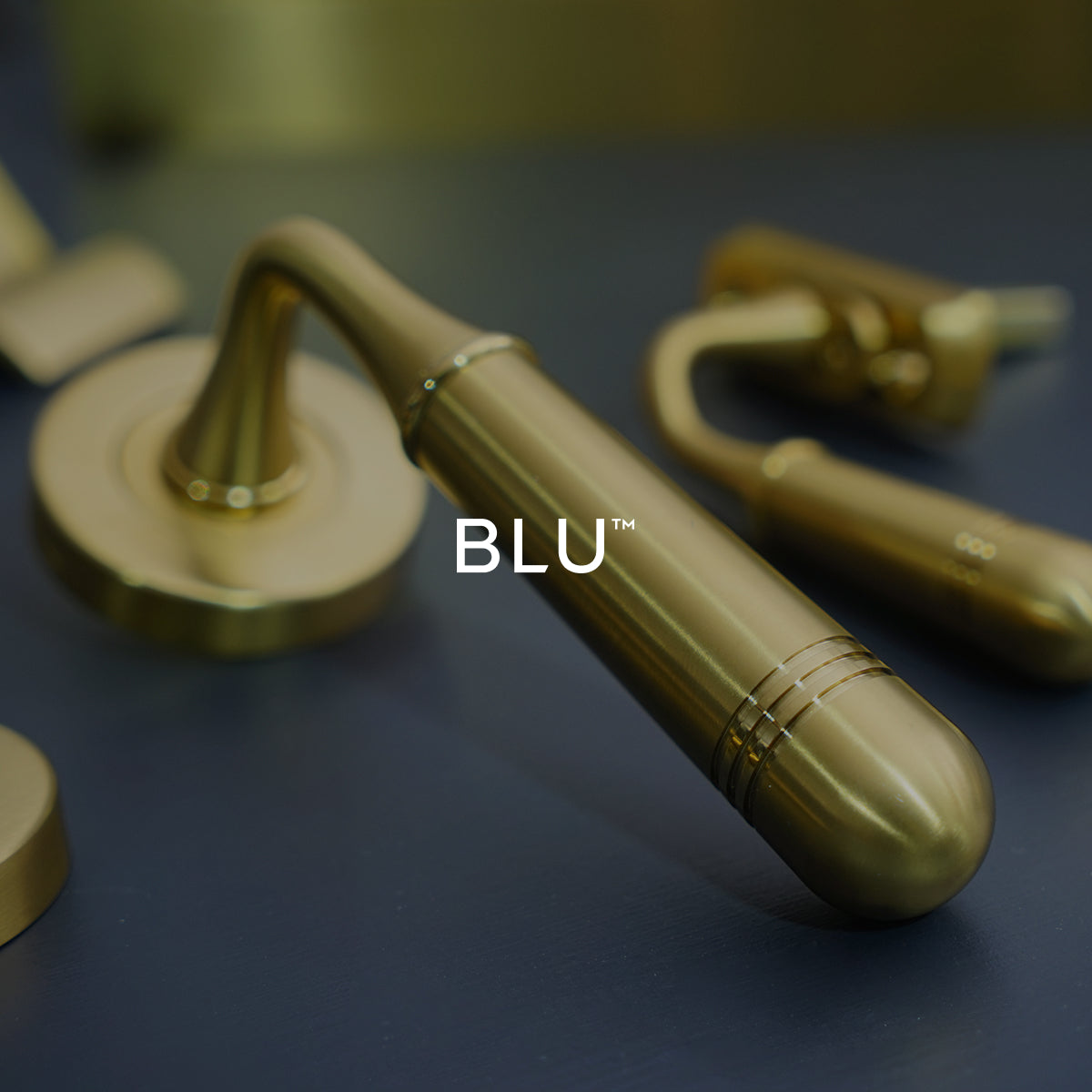 Satin brass finish door handle on a dark surface with 'BLU' branding.