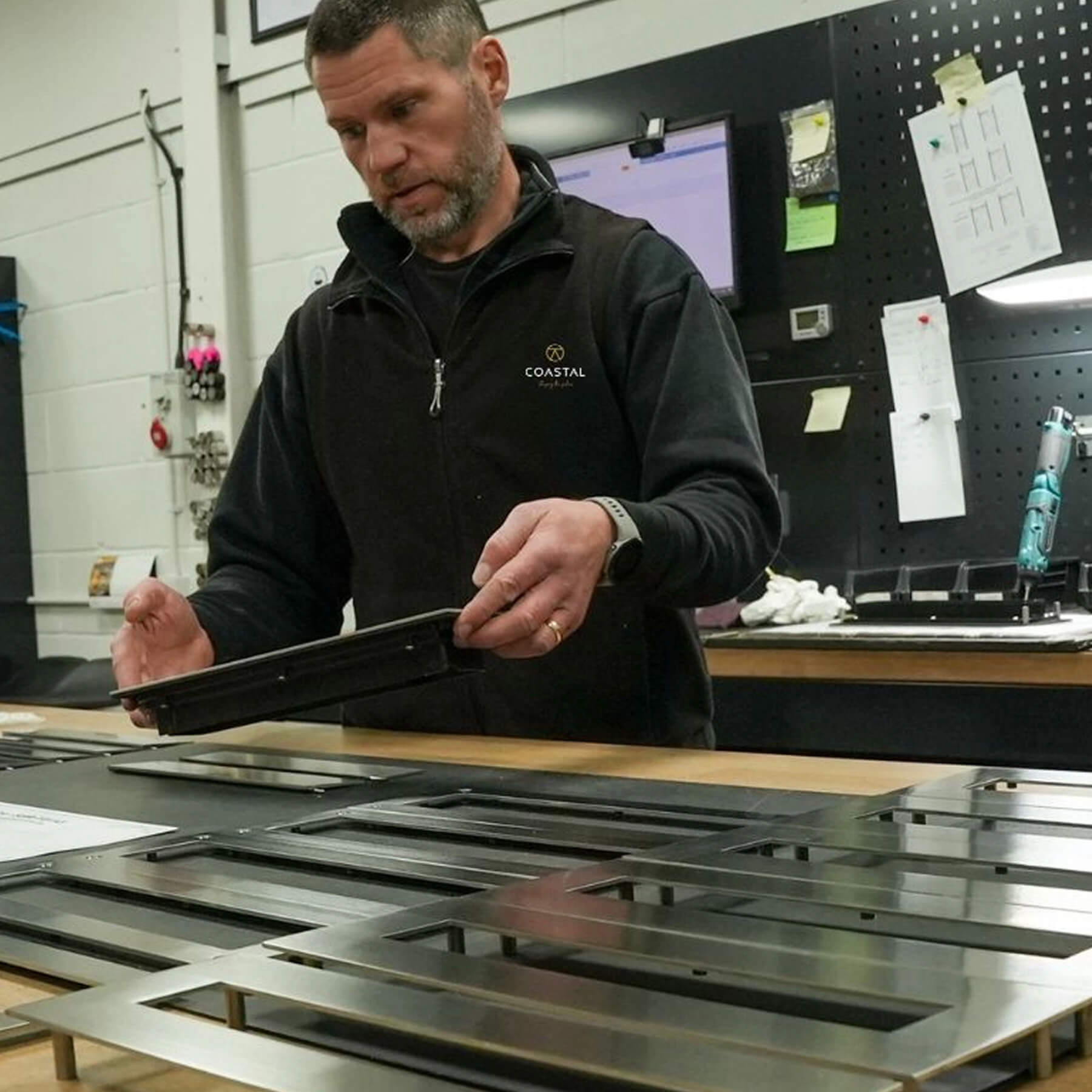 Man in a workshop building stainless steel premium letter plates